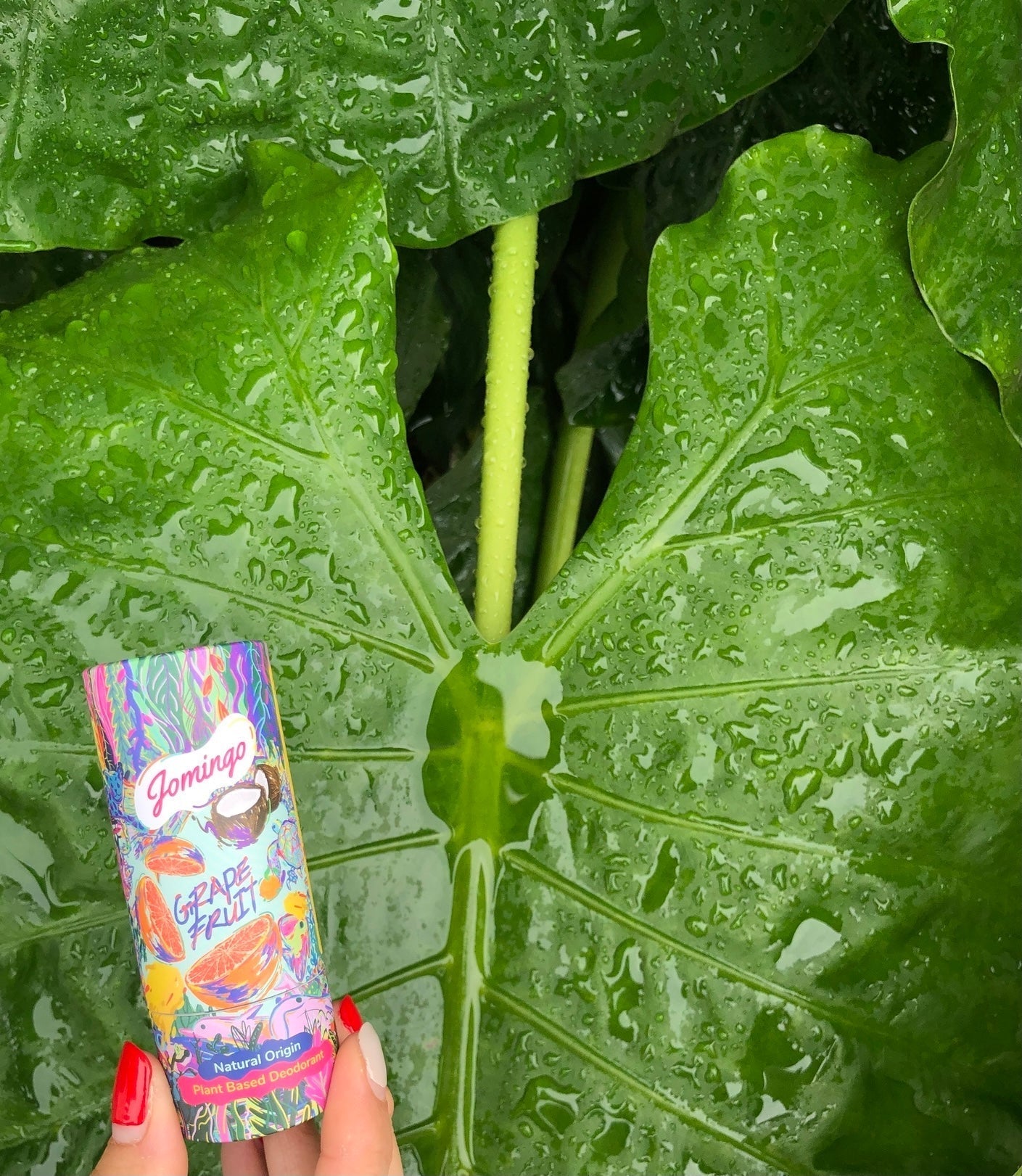 a picture of a deodorant with a background of leaves